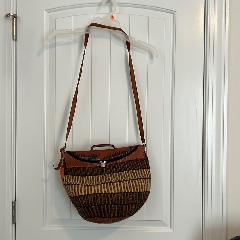 Hand Woven cross body. Had some leather around it.